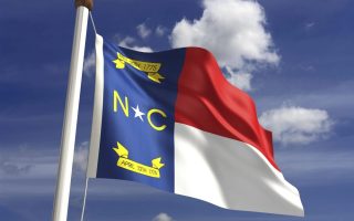 cost of living in North Carolina - NC flag waving in the wind