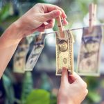 How to Prioritize Spending - money on a laundry line