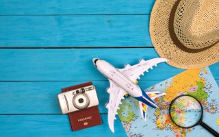 A toy plane, hat, and passport on a map