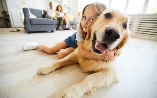 A young girl hugging her dog