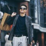 A man holding shopping bags and walking