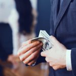 Man in a business suit spending cash