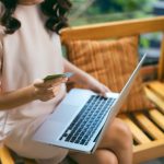 A woman shopping online on a laptop
