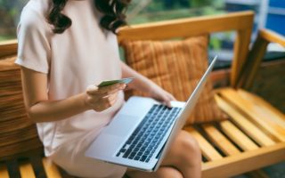 A woman shopping online on a laptop