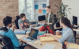 A work meeting with a woman holding a laptop
