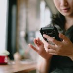 Smiling woman using a smartphone