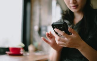 Smiling woman using a smartphone