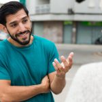 Bearded man explaining something to a woman