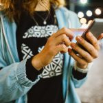 Woman typing on a phone
