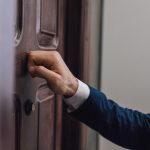 man knocking at a door