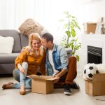happy couple moving in together with a lot of boxes