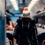 A woman walking on a train