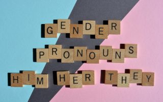 Gender pronouns written out in wooden blocks