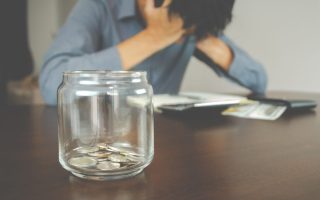 stressed man with coins in a jar