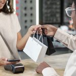 A woman buying an item in a bag