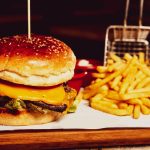 A greasy cheeseburger and french fries