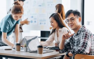 Gen Z workers at an office on computers