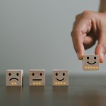 Multiple blocks with various emotional faces drawn on them