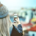 woman looking at her smartphone outside