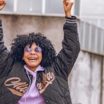 A confident woman pumping her hands in the air