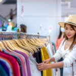 A woman shopping for clothing in a department store
