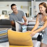 A couple buying a couch at a furniture store