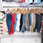 A closet full of hanging clothing