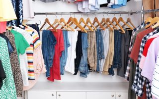 A closet full of hanging clothing