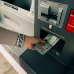 woman taking money from an ATM