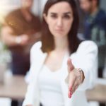 A confident woman offering her hand to shake