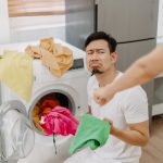 frowning man doing laundry