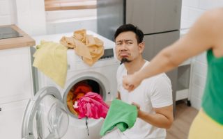 frowning man doing laundry