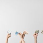 female hands holding up currency