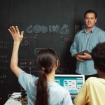 Teacher looking at a student raising their hand