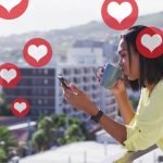 social media heart notifications as a woman drinks coffee