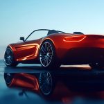 Stylish red convertible parked on a wet surface reflecting the evening sky in an urban area