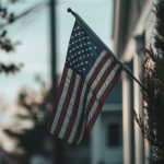 Small American flag in front of a house