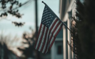 Small American flag in front of a house