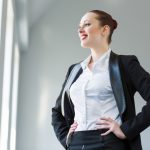 A business woman wearing a suit and smiling