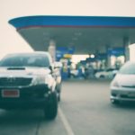 A couple of cars at a gas station