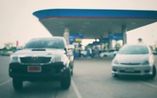 A couple of cars at a gas station