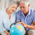 Baby boomer couple with a globe