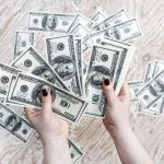Two hands holding a lot of cash