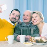 Adult son taking a selfie with his parents