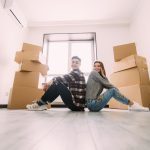 A couple moving into a small apartment with moving boxes