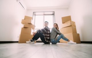 A couple moving into a small apartment with moving boxes