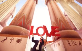 Bride and groom having fun near a big building