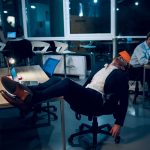 Businessman falling asleep during work.