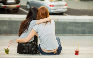 Two friends hugging each other, struggling together