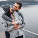 A young romantic couple near the water, sharing values and their religion